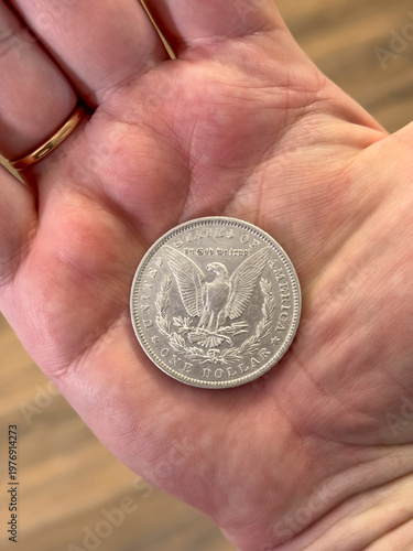 Tableau sur toile Stack of Dollars with Silver Coin