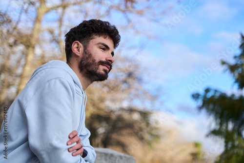 Εκτύπωση καμβά Young man contemplating outdoors wearing casual hoodie