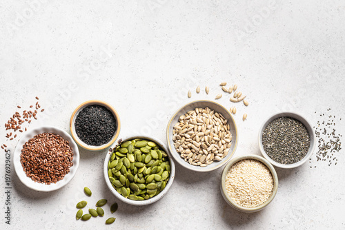 Photos Assortment of seeds in bowls for healthy eating
