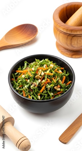 Healthy Salad in Black Bowl with Wooden Utensils
