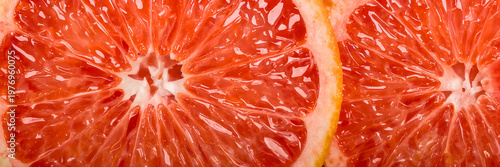 Macro close up of fresh grapefruit slices with juicy red pulp and citrus texture