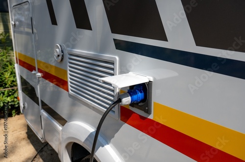 Obraz na plátně Camper van electrical hookup with power cable connected to RV outlet for mobile
