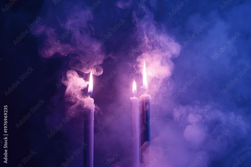 Fototapeta premium Two Tall Candles with Purple Smoke Rising on Dark Moody Background