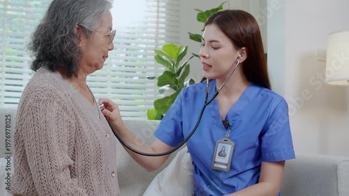Asian woman nurse using stethoscope for heart diagnosis with senior patient, medical checkup for elderly woman at home, cardiology consultation and healthcare service, checking lung and chest.