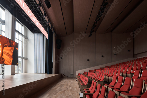 Fotografie Stage side view across a red seat theater auditorium