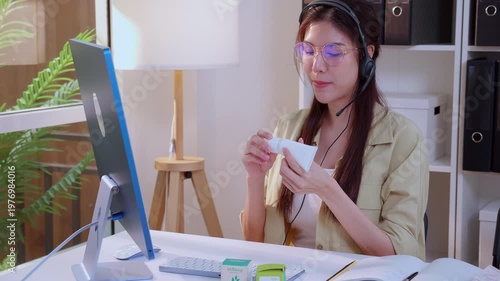 Young asian creative woman development packaging cosmetic and skincare product design with AI artificial intelligence, businesswoman using headset with marketing for conference online, call center.