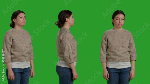 Фотография Close up of depressed model acting upset over greenscreen studio backdrop, being sad and displeased on camera