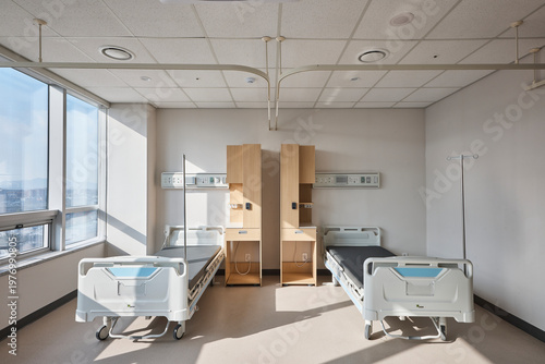 Patient room with beds and warm morning light in hospital ward