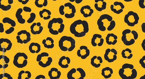 Classic animal print style is achieved with this bold black leopard spot pattern on a bright yellow background field.