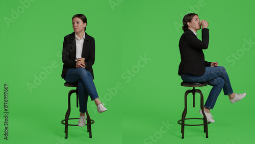 Fotografie Female manager drinking cup of coffee before working at office, sitting on chair in suit