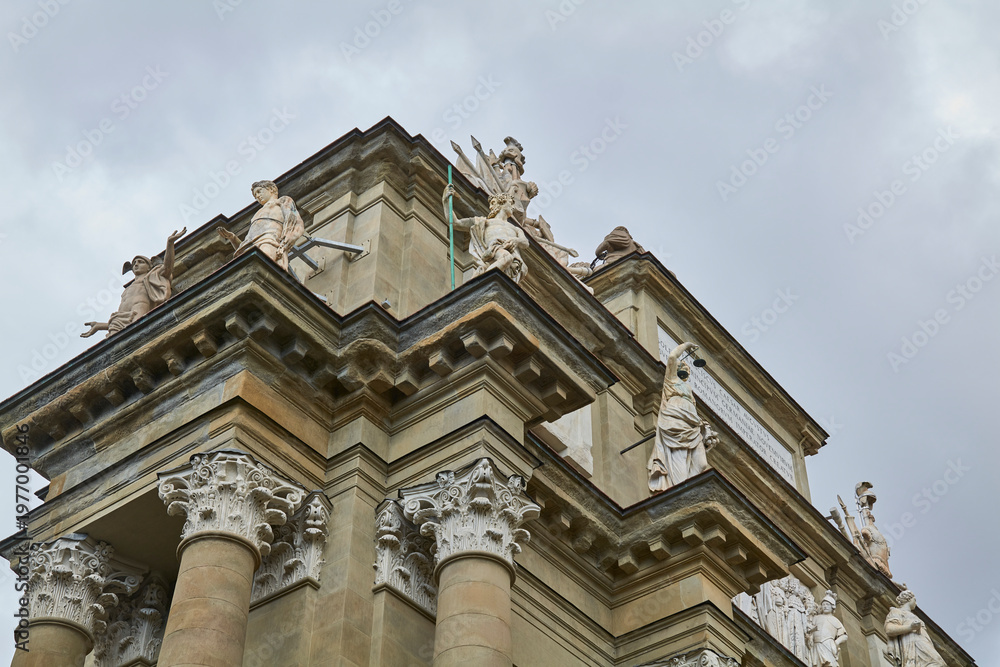 Fototapeta premium Ornate baroque church facade detail against gray sky