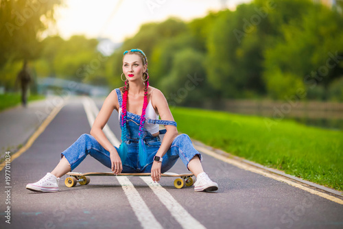 Portrait of Relaxed Dreaming Winsome Girl With Longboard On Long Tarmac Road Against Nature Background While Sitting On Skateboard