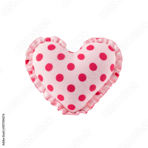 A pink heart shaped pillow with red polka dots