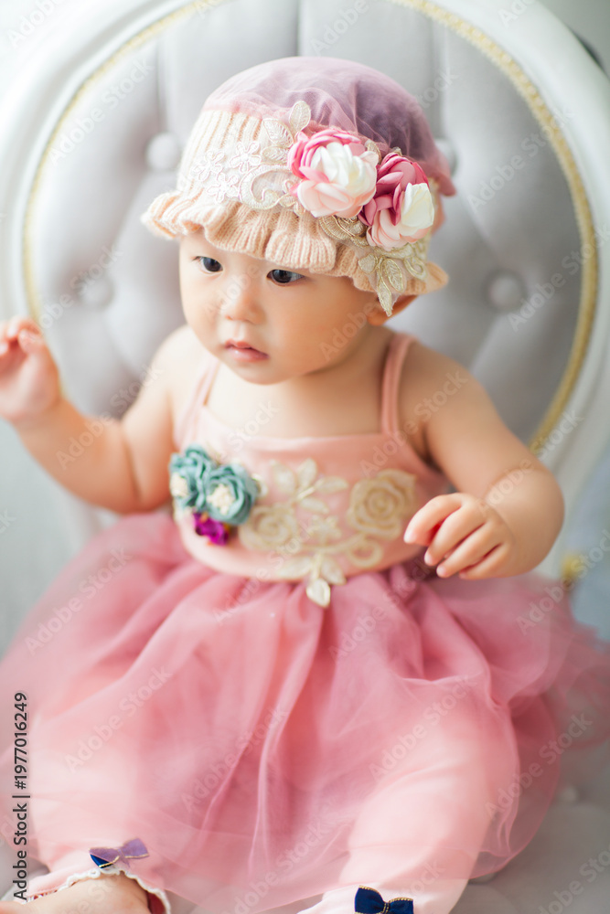 Fototapeta premium Cute Asian baby girl wearing a woolen hat