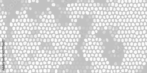 Abstract gray mosaic pattern with white cellular shapes, organic texture background for modern graphic design layout. A densely patterned abstract background featuring numerous irregular white shapes 