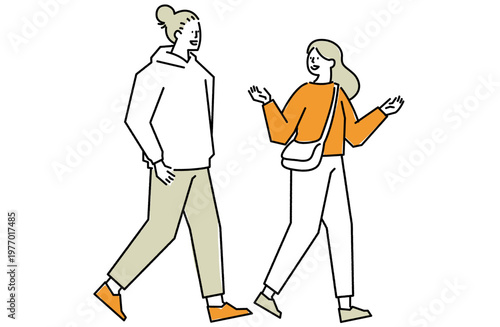 笑い合いながら歩く仲の良い若者カップル