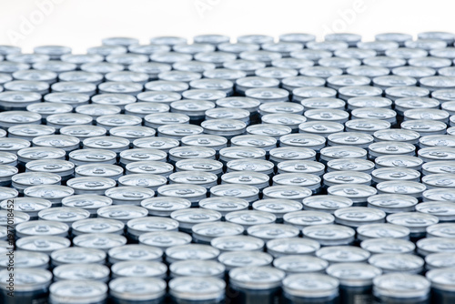 Stack of aluminum beer cans forming repetitive industrial