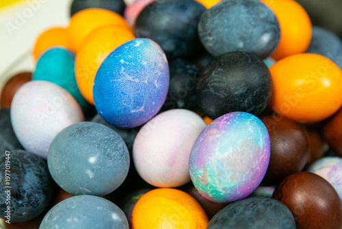 Colorful dyed Easter eggs in glass bowl – traditional holiday decoration