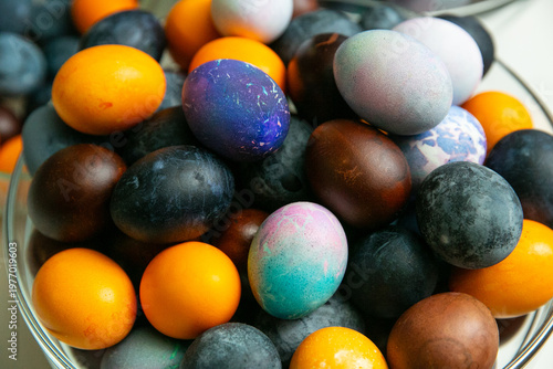 Colorful dyed Easter eggs in glass bowl – traditional holiday decoration