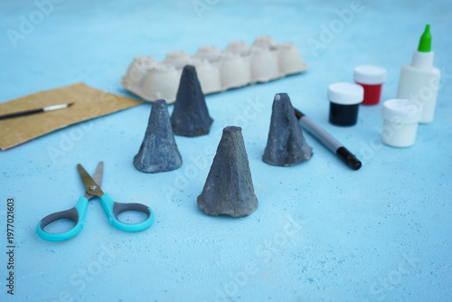 A simple DIY childrens craft is a family of mice made from cardboard egg packaging. Color it in gray, close up.