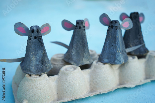 A family of mice, hand-made from a cardboard egg box, close-up. An eco-friendly idea for reuse, decorations for Easter, a gift for dad, mom, on family day.