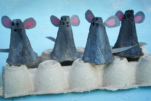 A family of mice, hand-made from a cardboard egg box, close-up. An eco-friendly idea for reuse, decorations for Easter, a gift for dad, mom, on family day.