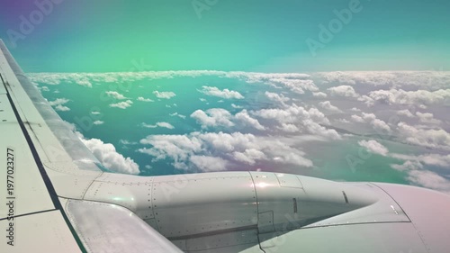 Beautiful view of airplane wing flying above fluffy clouds over Atlantic ocean with distant islands. Miami. USA.