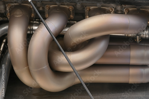 Chichester, United Kingdom - 21 July 2018: View of the exhaust manifold with its complex curves and metallic sheen, reflecting light and heat in a symphony of engineering precision.