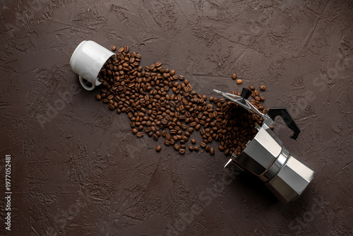 Geyser coffee maker with white cup and coffee beans on brown stone background, top view. Food concept photo