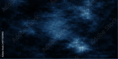 A dark blue grunge abstract background captures the atmospheric texture of a stormy night sky where light pierces through heavy rain clouds