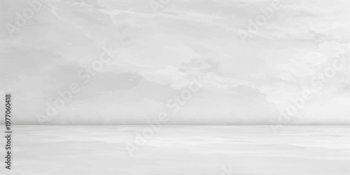 A serene winter landscape where the snow-covered wall and road meet the horizon under a blue sky reflecting off the cold water of a white ocean