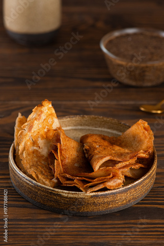 Thin gluten free pancakes with vegan chia caviar. Dairy free, healthy breakfast. Vertical orientation.