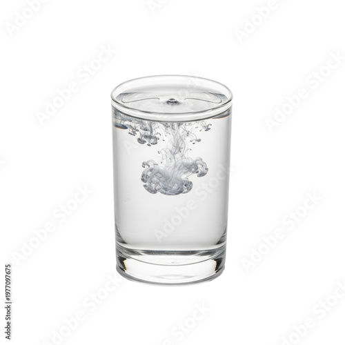 Top-down macro view of white powder dissolving in a glass of pure water on a white background creating abstract trails. Concept of purity and chemical reaction