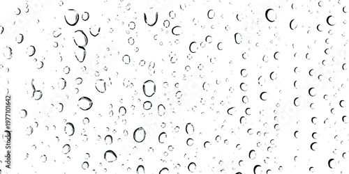 A detailed close up view of numerous rain drops scattered across a transparent window glass pane