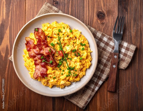 Breakfast plate with eggs, bacon, and chives