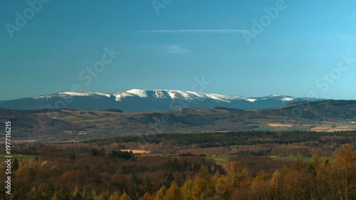 View of Western Karkonosze from Polish side, snow, blue sky with clouds, zoom shot