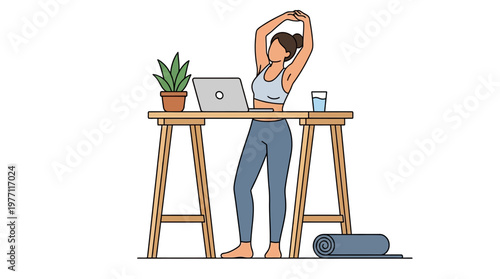 Woman stretches while standing at desk with laptop and yoga mat nearby, wearing workout clothes.