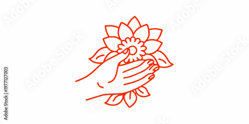 Praying hands gently holding a blossoming lotus flower in red