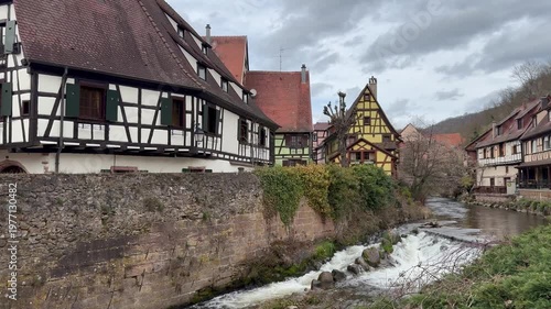 Traditional timberframe houses at Kaysersberg town centre. Motion of Weiss river water. Panoramic, scenic view. Kaysersberg, Alsace, France