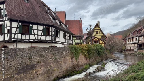 Traditional timberframe houses at Kaysersberg town centre. Motion of Weiss river water. Panoramic, scenic view. Kaysersberg, Alsace, France