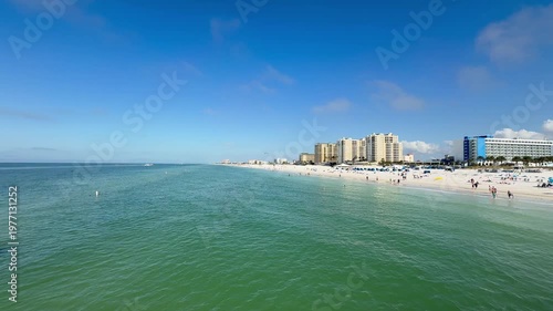 Panoramic, scenic view of Clearwater Island Beach skyline. People are swimming and walking around white sand beach. High rise hotel buildings. Clearwater Beach, Florida 