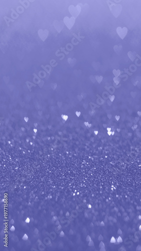 Shimmering purple glitter background featuring soft-focus heart bokeh, perfect for celebratory and romantic themes