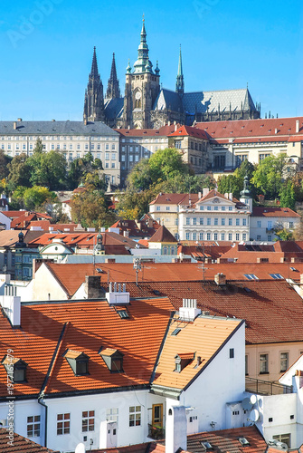 Vertical panoramic view of Prague rooftops with the castle rising in the background, blending history and timeless charm