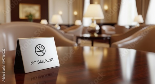 A sign on a wooden table indicates no smoking in a room with chairs and lamps.