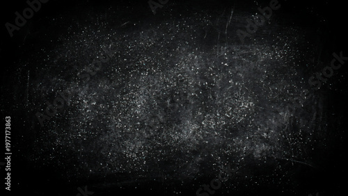 White particles and powder scattered on dark surface with scratches and marks everywhere abstract texture