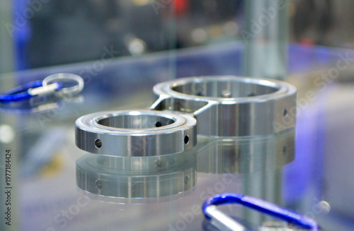 Metal part manufactured using CNC machining. Part made by metalworking CNC machine from metal. Polished aluminum or stainless steel. High-precision milling followed by polishing. Production technology