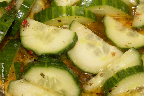 Close up spicy chopped sliced cucumber in olive oil salad and chili