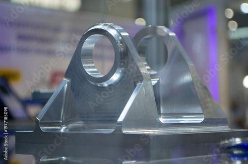 Metal part manufactured using CNC machining. Part made by metalworking CNC machine from metal. Polished aluminum or stainless steel. High-precision milling followed by polishing. Production technology