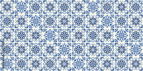 Blue and white azulejo tile pattern with ornate floral and geometric motifs. Traditional Portuguese ceramic mosaic background inspired by vintage decorative wall tiles and classic Mediterranean style.