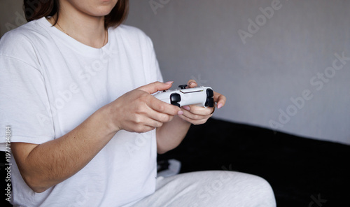 A young girl playing video games. Concept of entertainment, technology, leisure, and modern lifestyle.